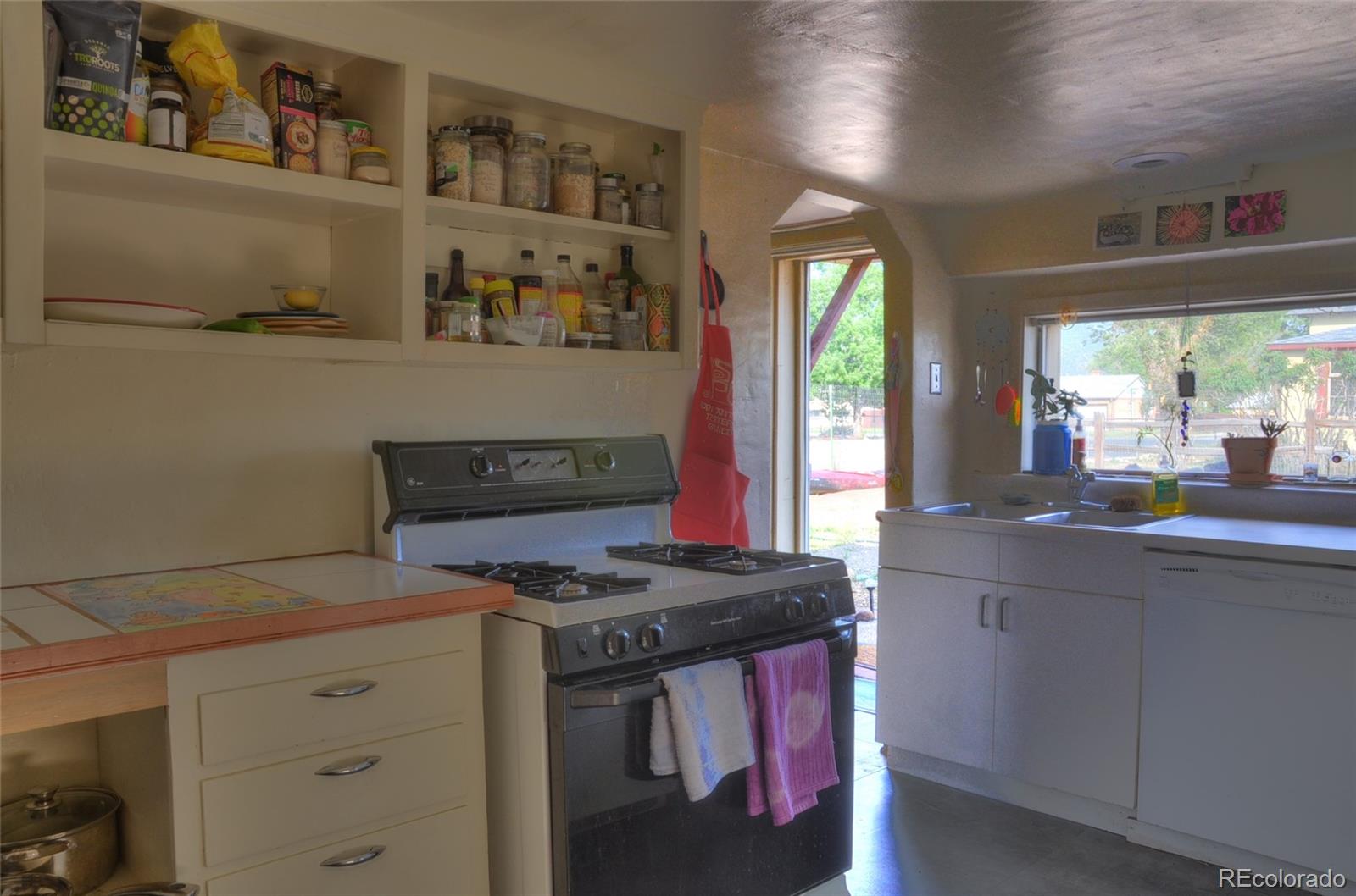 1406 G Street, Unit B Salida, CO 81201 - Photo 11 of 24 a kitchen with stainless steel appliances granite countertop a stove a sink and a refrigerator