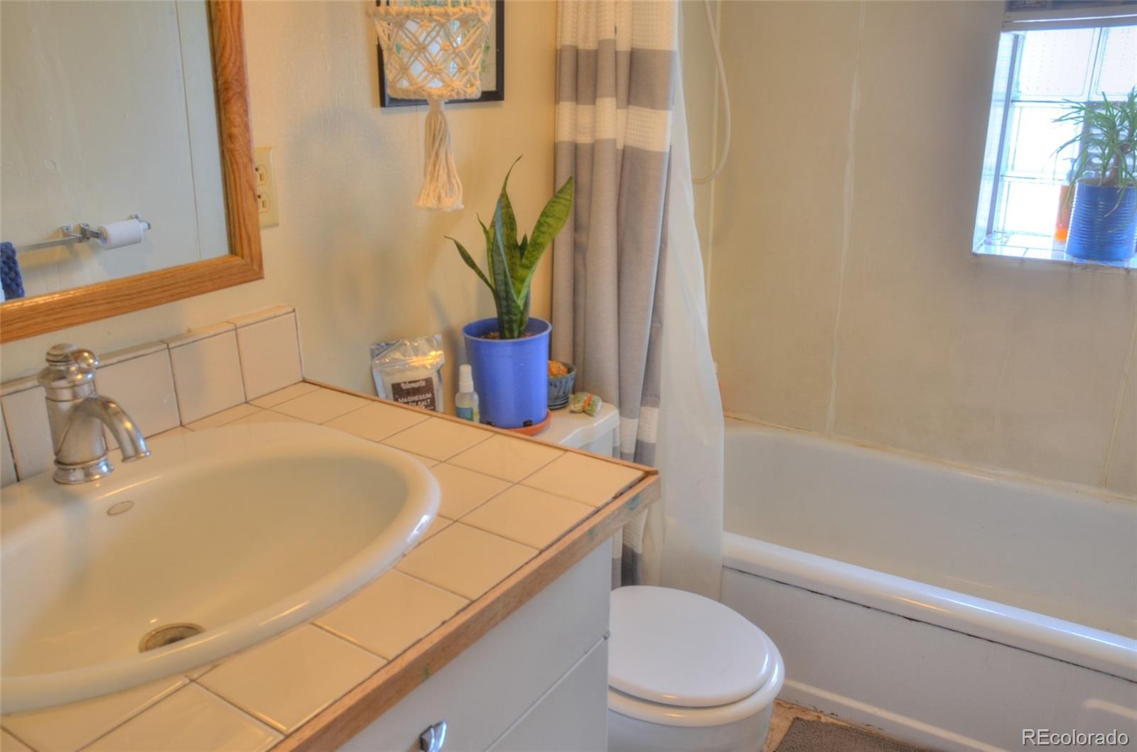 1406 G Street, Unit B Salida, CO 81201 - Photo 16 of 24 a bathroom with a sink a toilet and tub