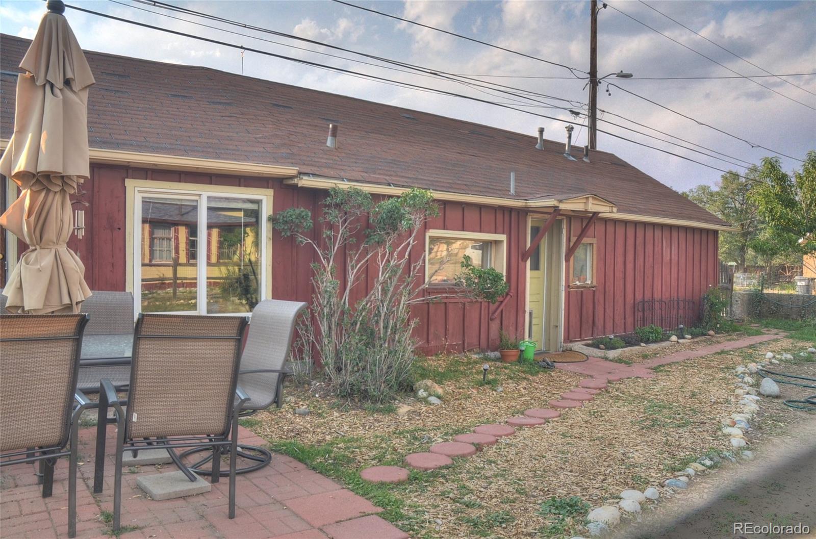 1406 G Street, Unit B Salida, CO 81201 - Photo 4 of 24 a view of a patio with table and chairs and wooden fence