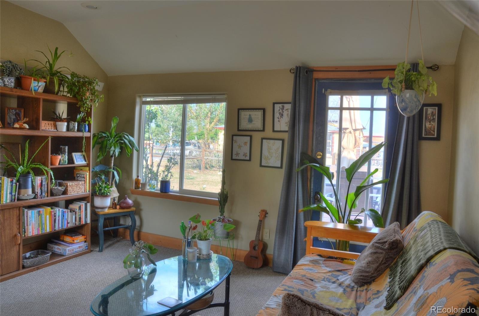 1406 G Street, Unit B Salida, CO 81201 - Photo 5 of 24 a living room with furniture toys and a book shelf