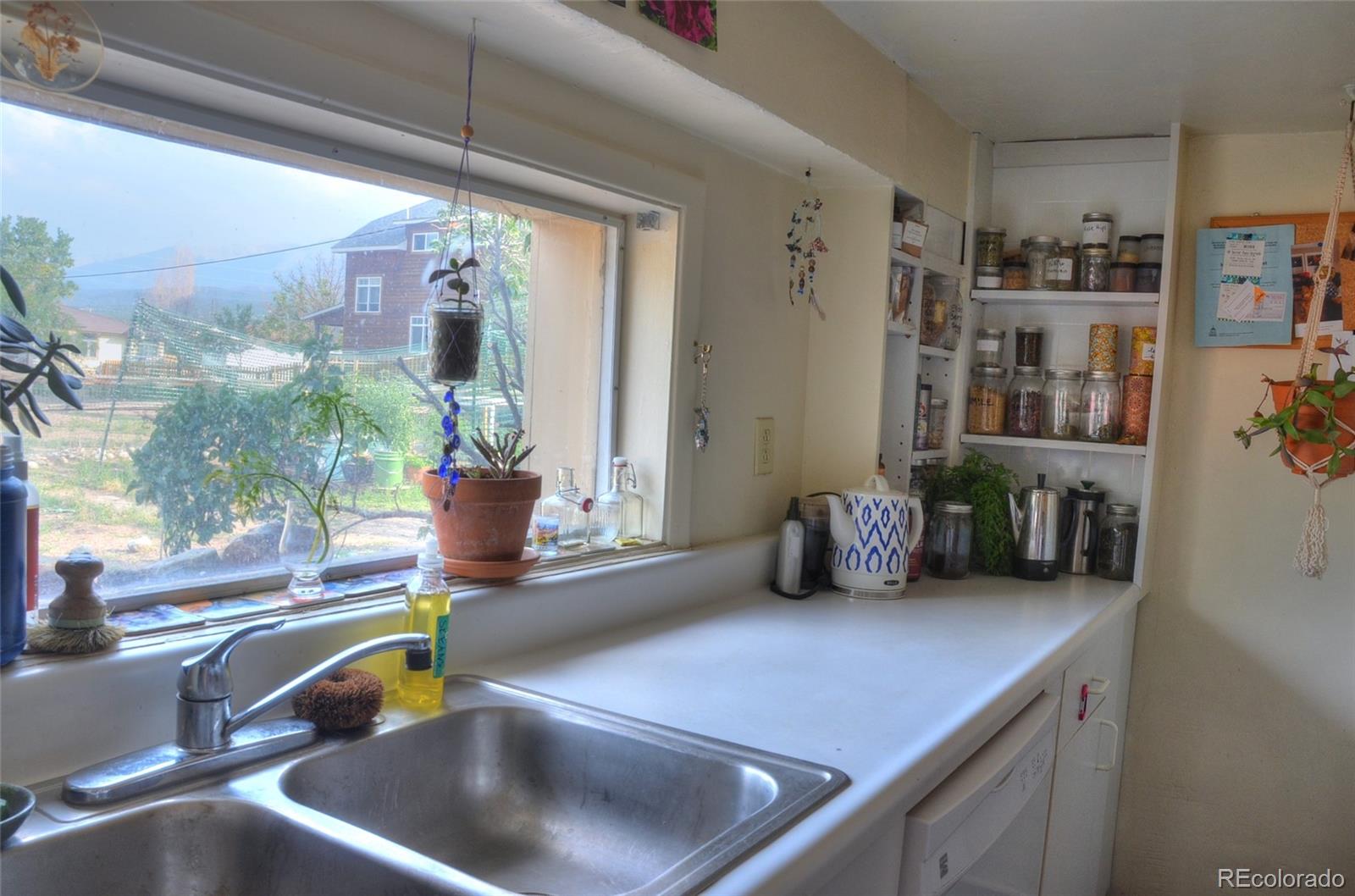 1406 G Street, Unit B Salida, CO 81201 - Photo 10 of 24 a kitchen with a sink a counter and a potted plant
