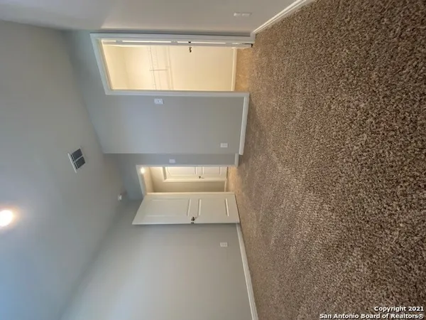 a view of an empty room with a window