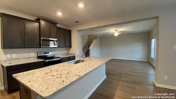 a kitchen with a sink and a refrigerator