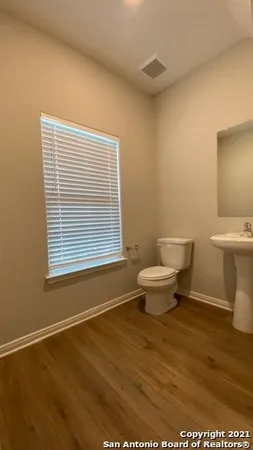 a bathroom with a toilet a window and a bathtub