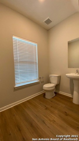 9310 Bennett Forest Converse, TX 78109 - Photo 21 of 24 a bathroom with a toilet a window and a bathtub