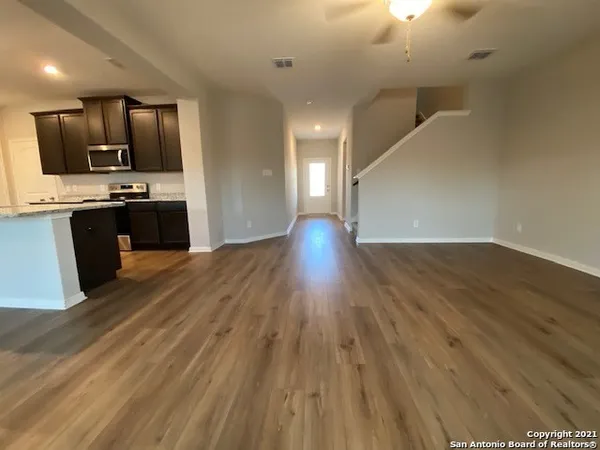 a view of kitchen with sink and wooden floor