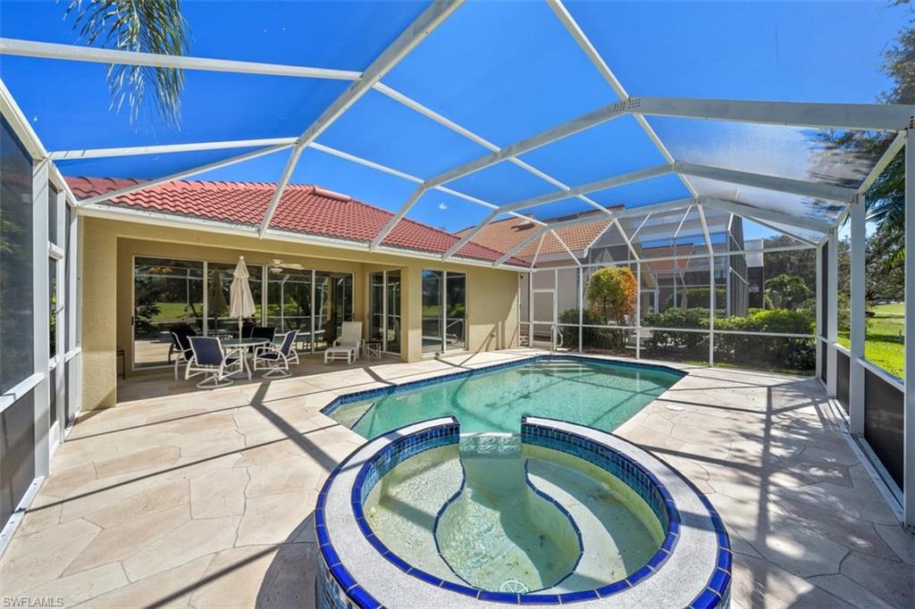156 Napa Ridge Way Naples, FL 34119 - Photo 1 of 21 a swimming pool with outdoor seating and yard