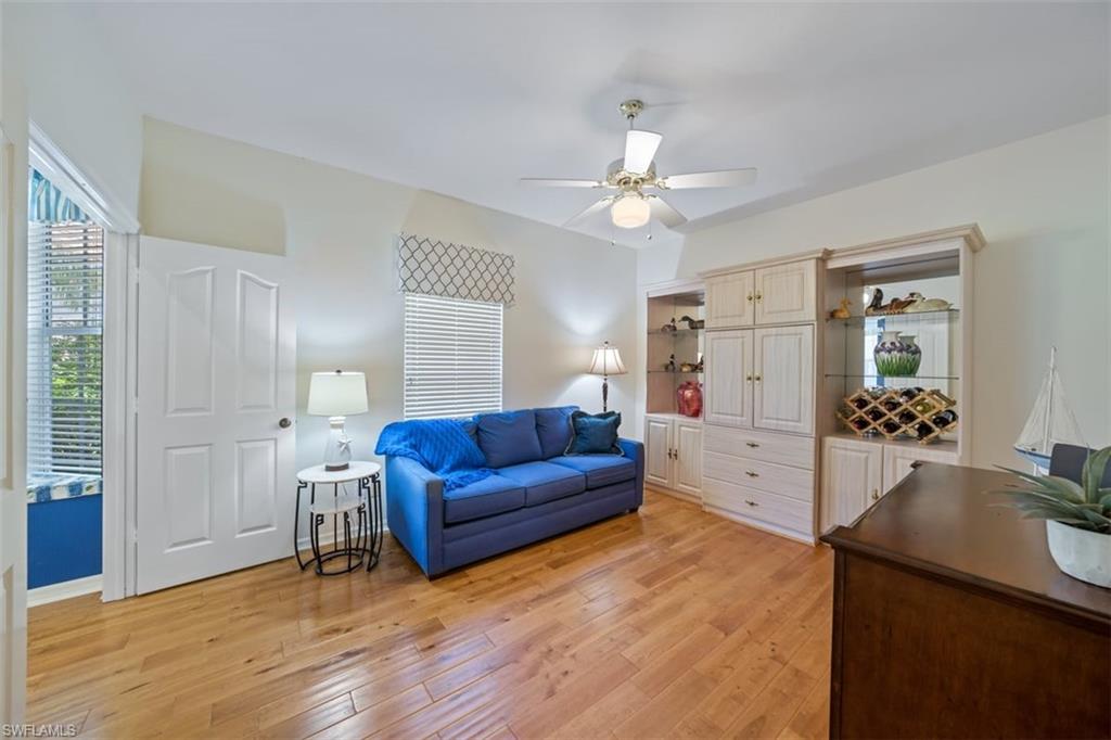 156 Napa Ridge Way Naples, FL 34119 - Photo 12 of 21 a living room with furniture and wooden floor