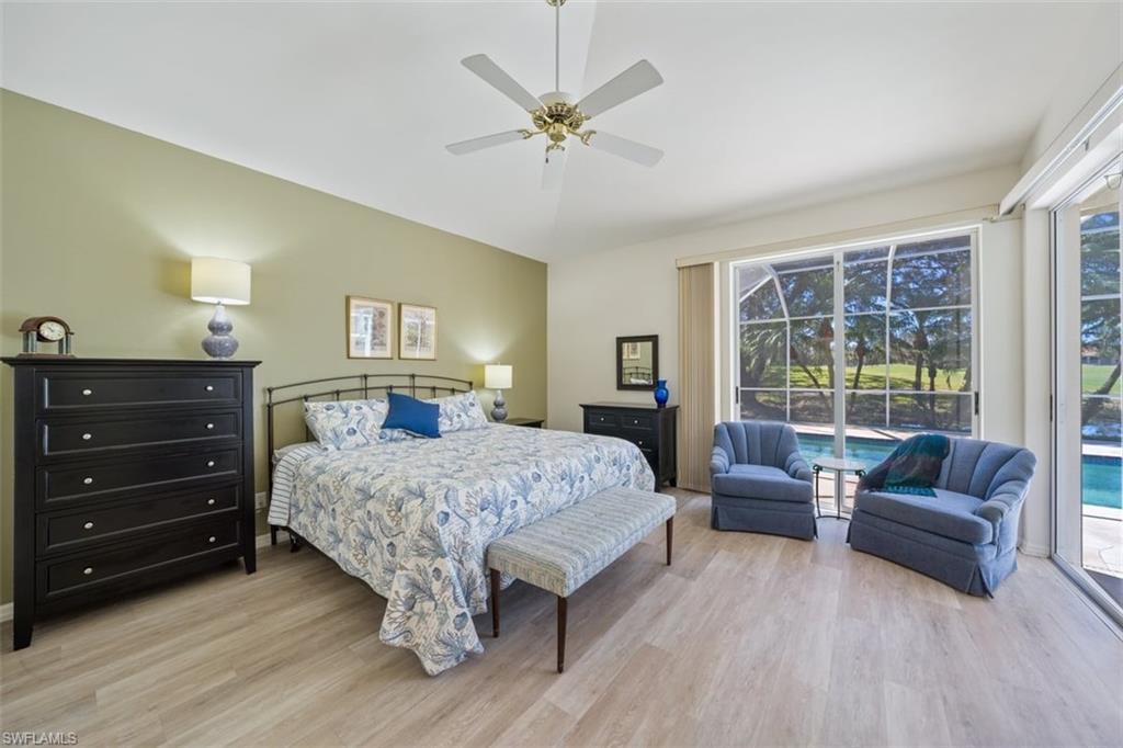 156 Napa Ridge Way Naples, FL 34119 - Photo 13 of 21 a bedroom with a bed and a couch