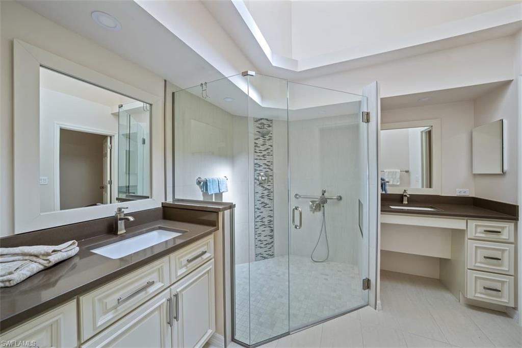 156 Napa Ridge Way Naples, FL 34119 - Photo 16 of 21 a spacious bathroom with a granite countertop sink mirror and double
