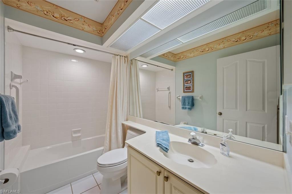 156 Napa Ridge Way Naples, FL 34119 - Photo 18 of 21 a bathroom with a sink a toilet and shower