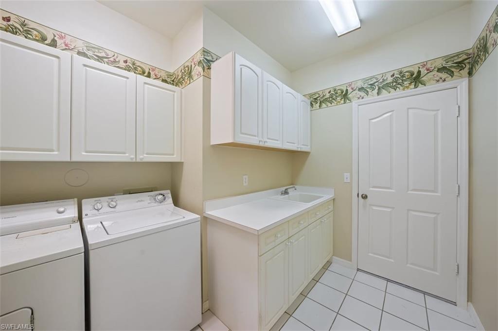 156 Napa Ridge Way Naples, FL 34119 - Photo 19 of 21 a utility room with dryer and washer