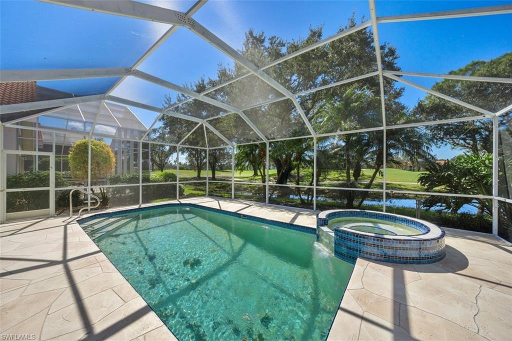 156 Napa Ridge Way Naples, FL 34119 - Photo 20 of 21 a view of a backyard with swimming pool and furniture