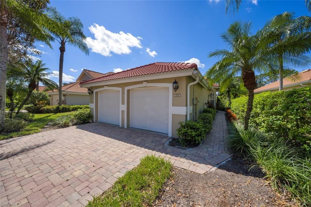 156 Napa Ridge Way Naples, FL 34119 - Photo 2 of 21 a view of a house with a small yard and a palm tree
