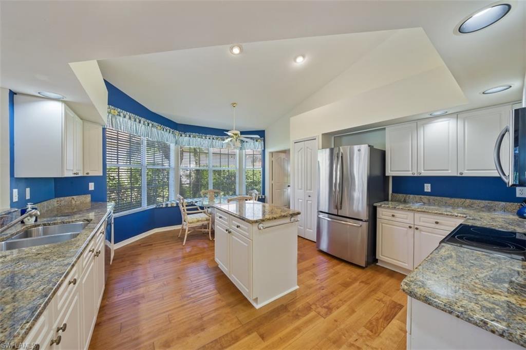 156 Napa Ridge Way Naples, FL 34119 - Photo 7 of 21 a kitchen with a refrigerator and a sink