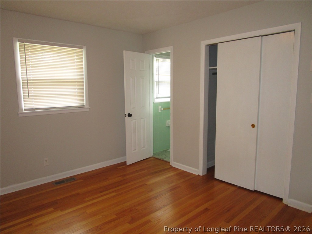 2516 Cumberland Road Fayetteville, NC 28306 - Photo 11 of 20 an empty room with wooden floor and windows