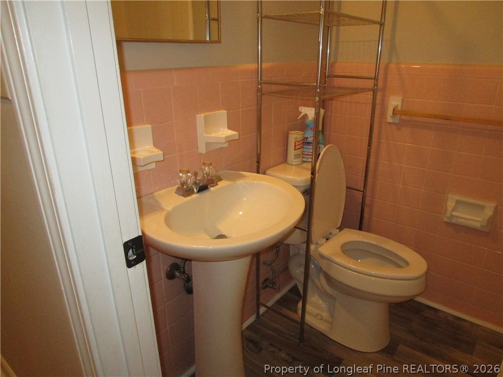 2516 Cumberland Road Fayetteville, NC 28306 - Photo 14 of 20 a bathroom with a sink toilet and mirror