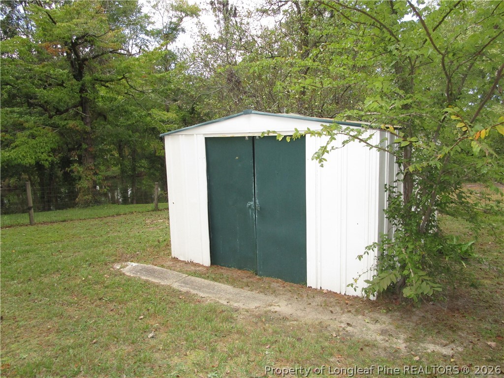 2516 Cumberland Road Fayetteville, NC 28306 - Photo 19 of 20 a backyard of a house with lots of green space
