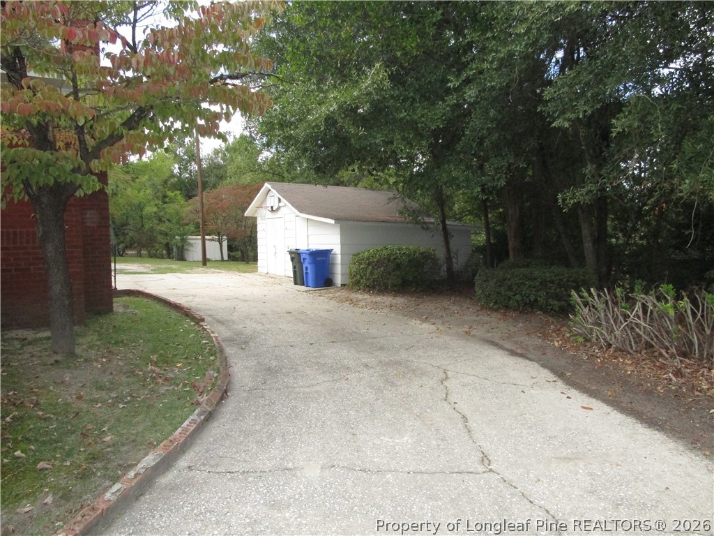 2516 Cumberland Road Fayetteville, NC 28306 - Photo 20 of 20 a front view of a house with a yard and trees