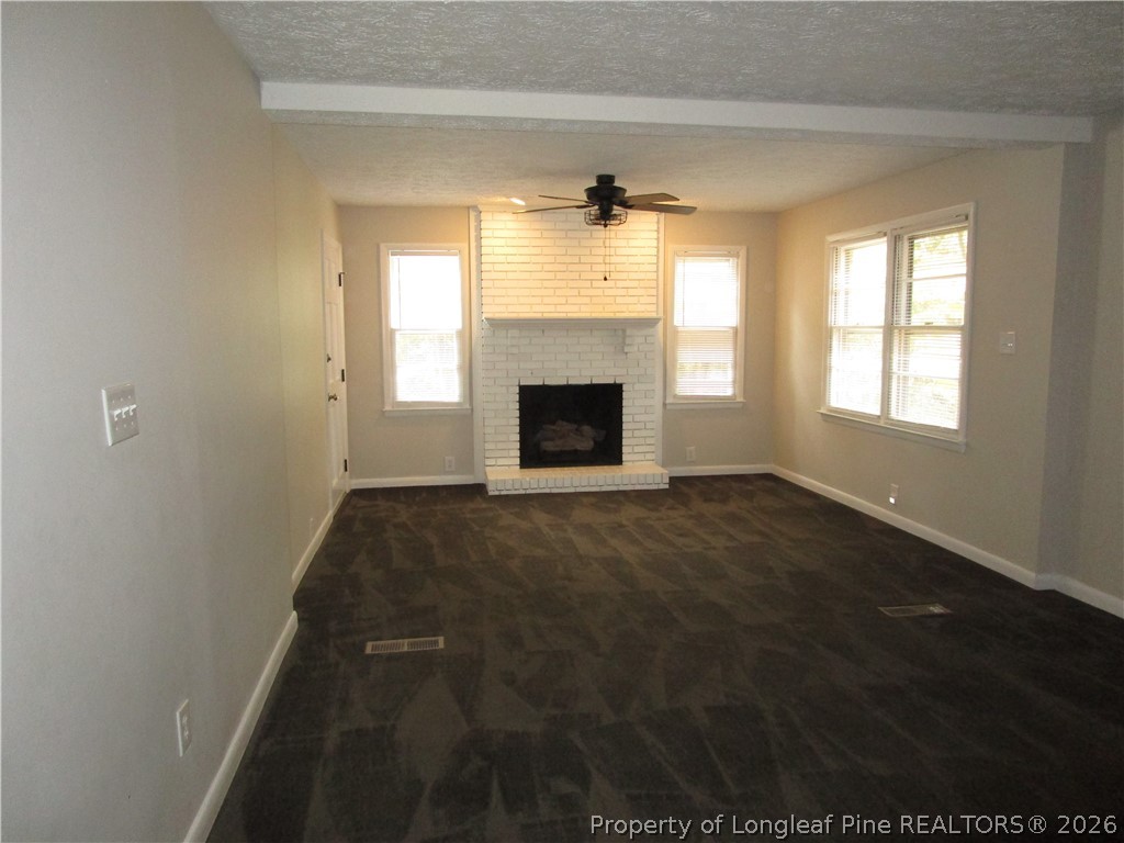 2516 Cumberland Road Fayetteville, NC 28306 - Photo 5 of 20 an empty room with windows and fireplace