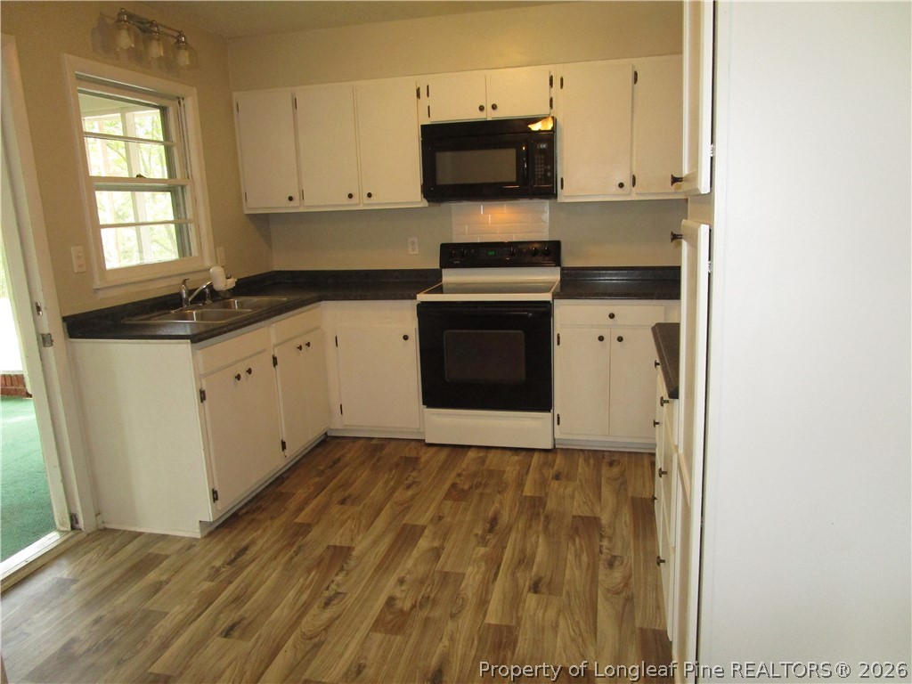 2516 Cumberland Road Fayetteville, NC 28306 - Photo 7 of 20 a kitchen with granite countertop a sink and a stove top oven