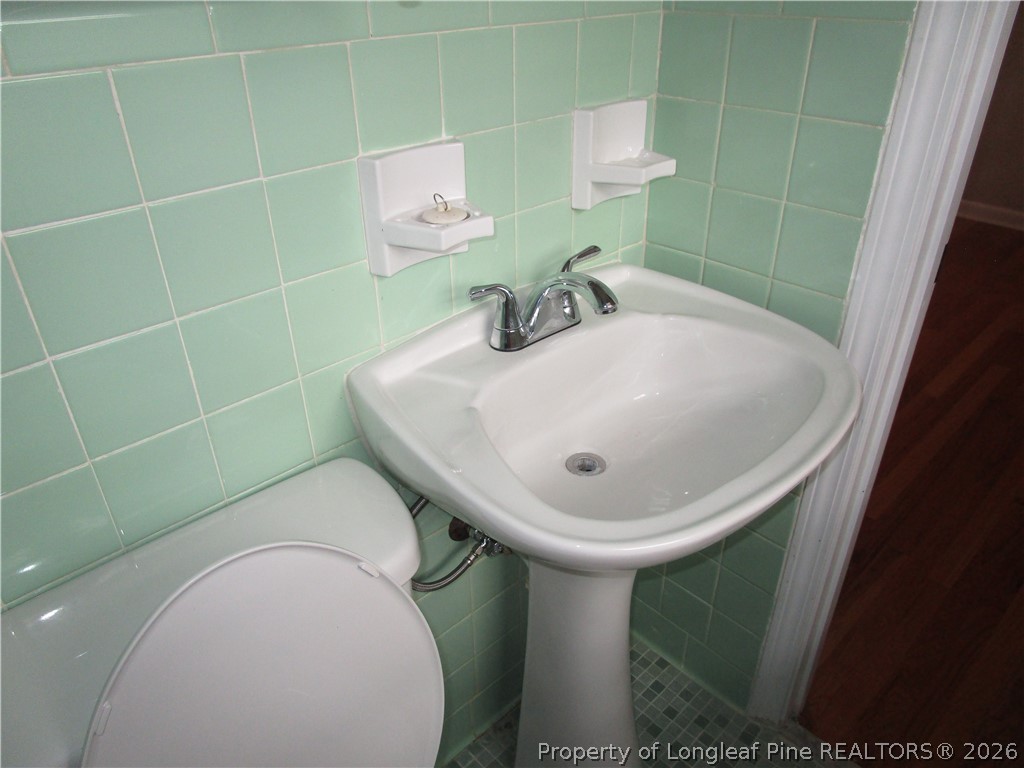 2516 Cumberland Road Fayetteville, NC 28306 - Photo 9 of 20 a bathroom with a sink toilet and shower