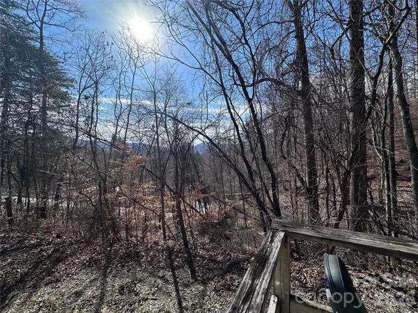 a view of mountain with wooden fence