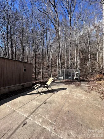 a view of a backyard with wooden fence