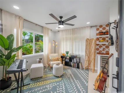 a living room with furniture a fireplace and a large window