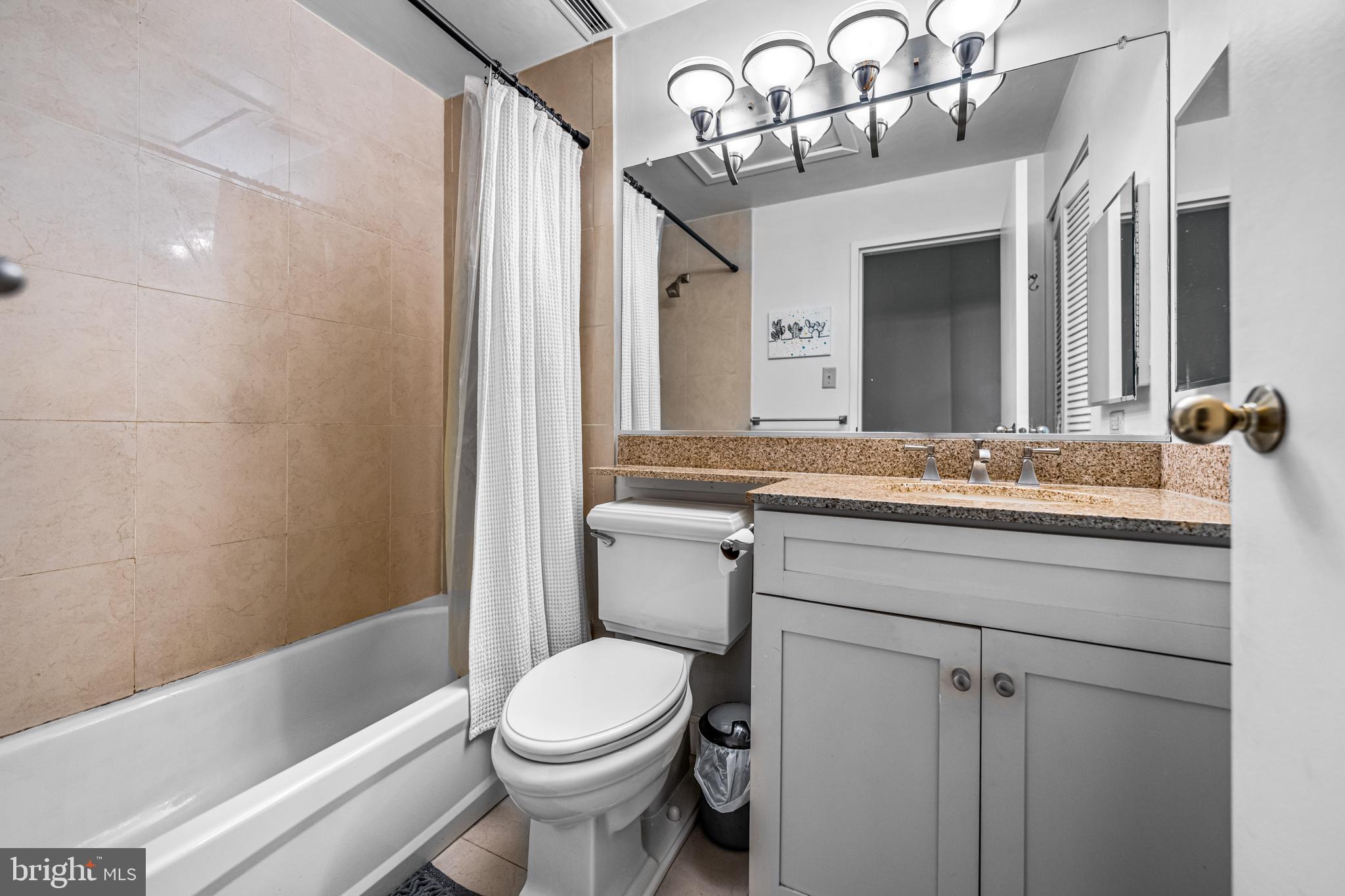 2429-41 Locust Street, Unit 219 Philadelphia, PA 19103 - Photo 20 of 28 a bathroom with a sink a toilet and shower