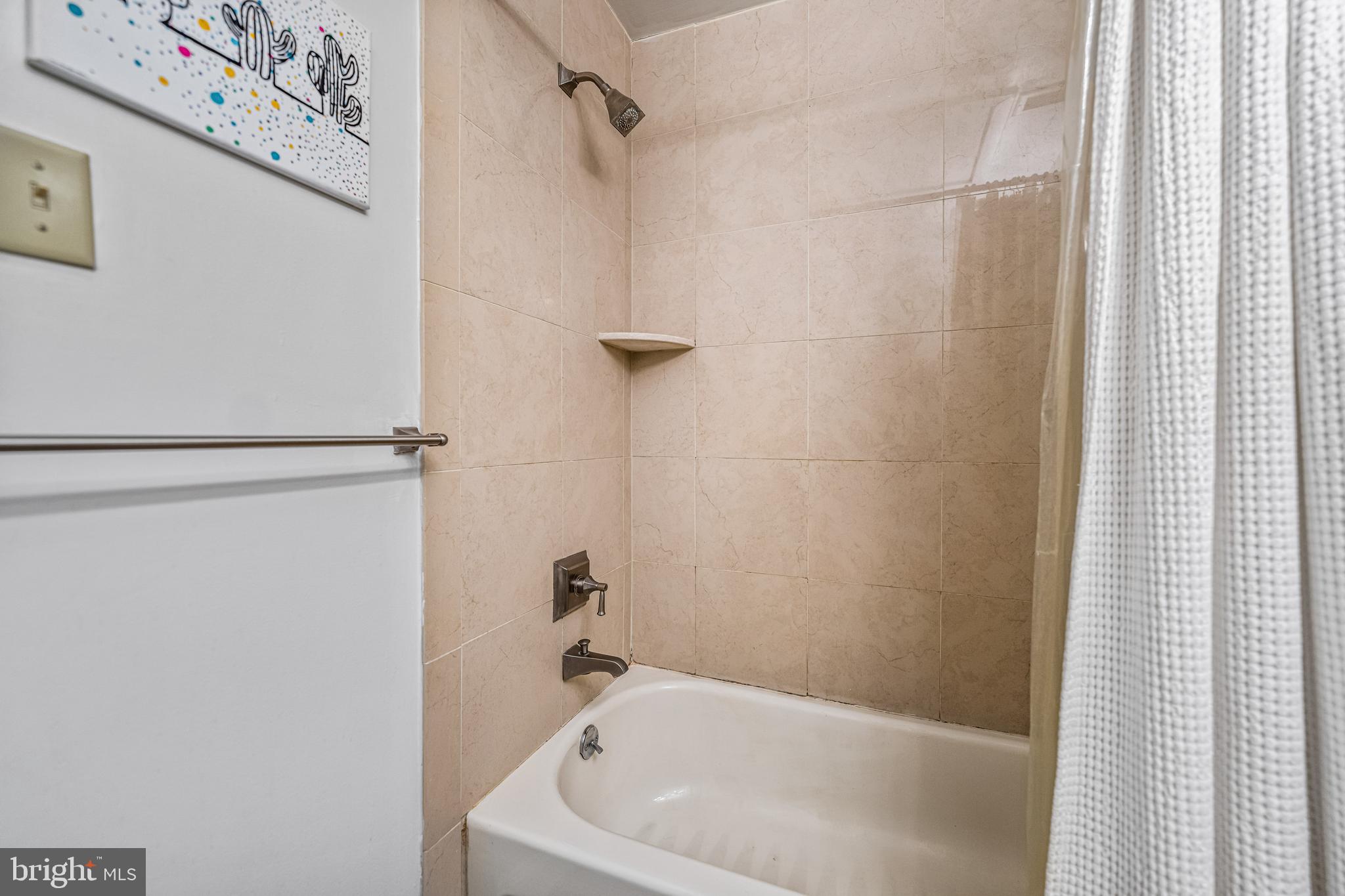 2429-41 Locust Street, Unit 219 Philadelphia, PA 19103 - Photo 21 of 28 a bathroom with a bathtub