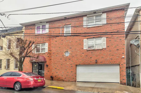 a front view of a house with parking space