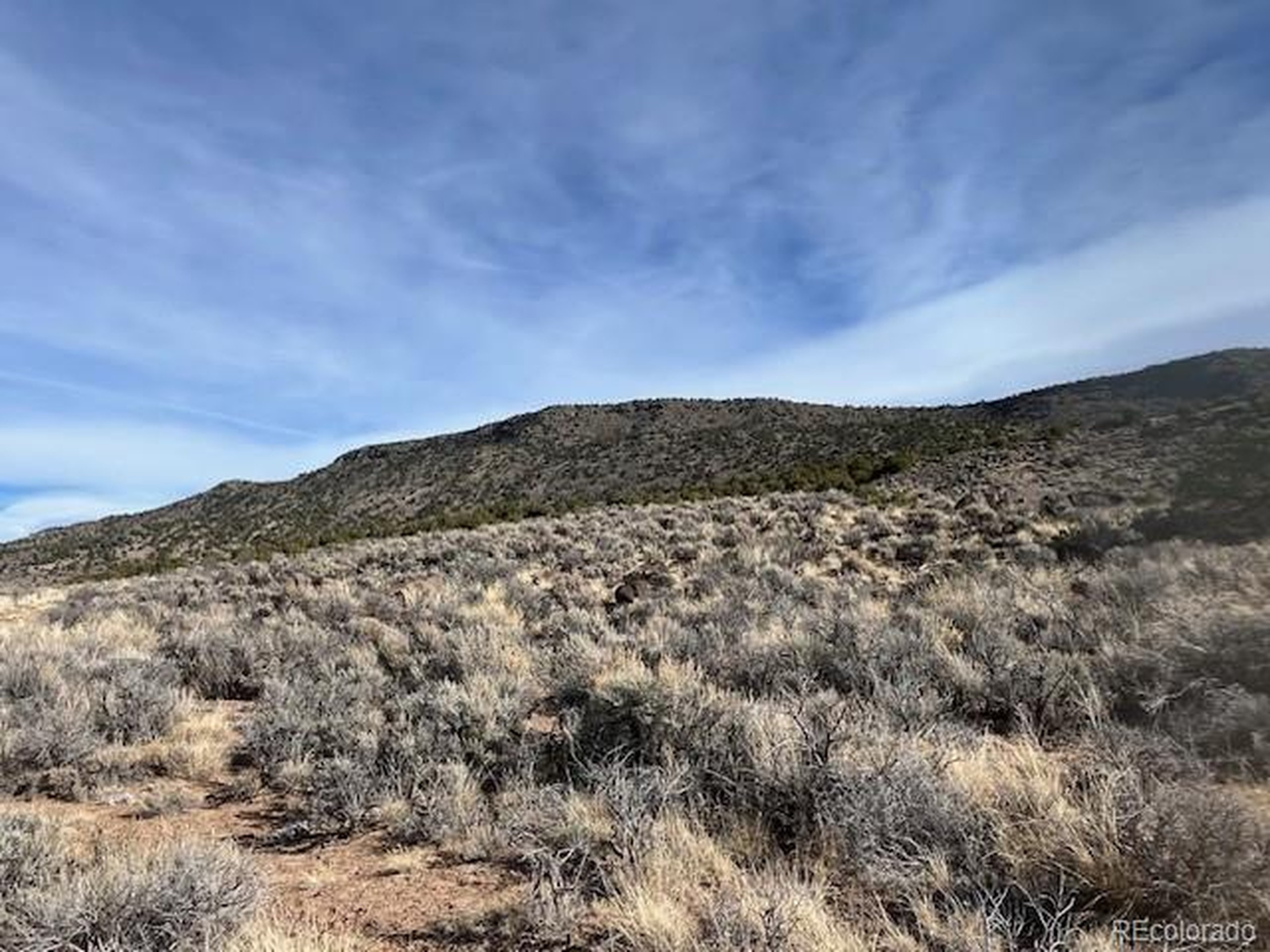 72 Stagecoach Road San Luis, CO 81152 - Photo 14 of 21 a view of a large building with mountains in the background