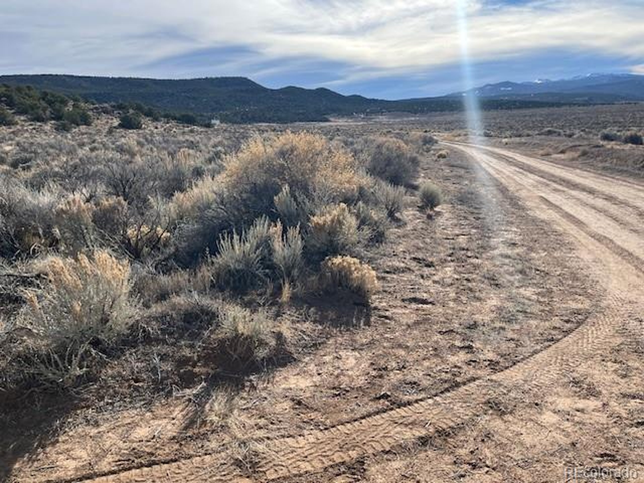 72 Stagecoach Road San Luis, CO 81152 - Photo 17 of 21 a view of a dry yard with wooden fence
