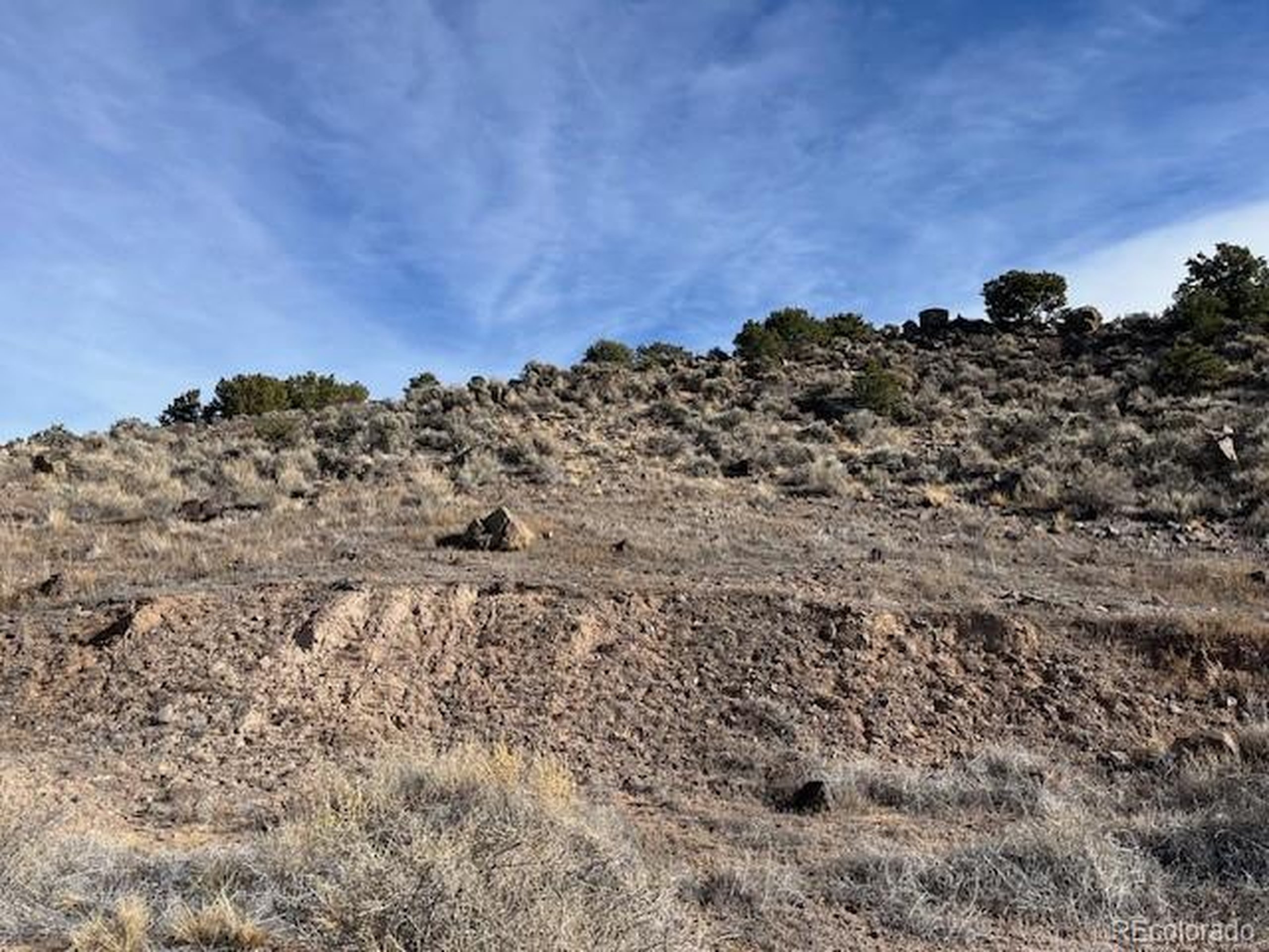 72 Stagecoach Road San Luis, CO 81152 - Photo 8 of 21 a view of a large building with a mountain in the background