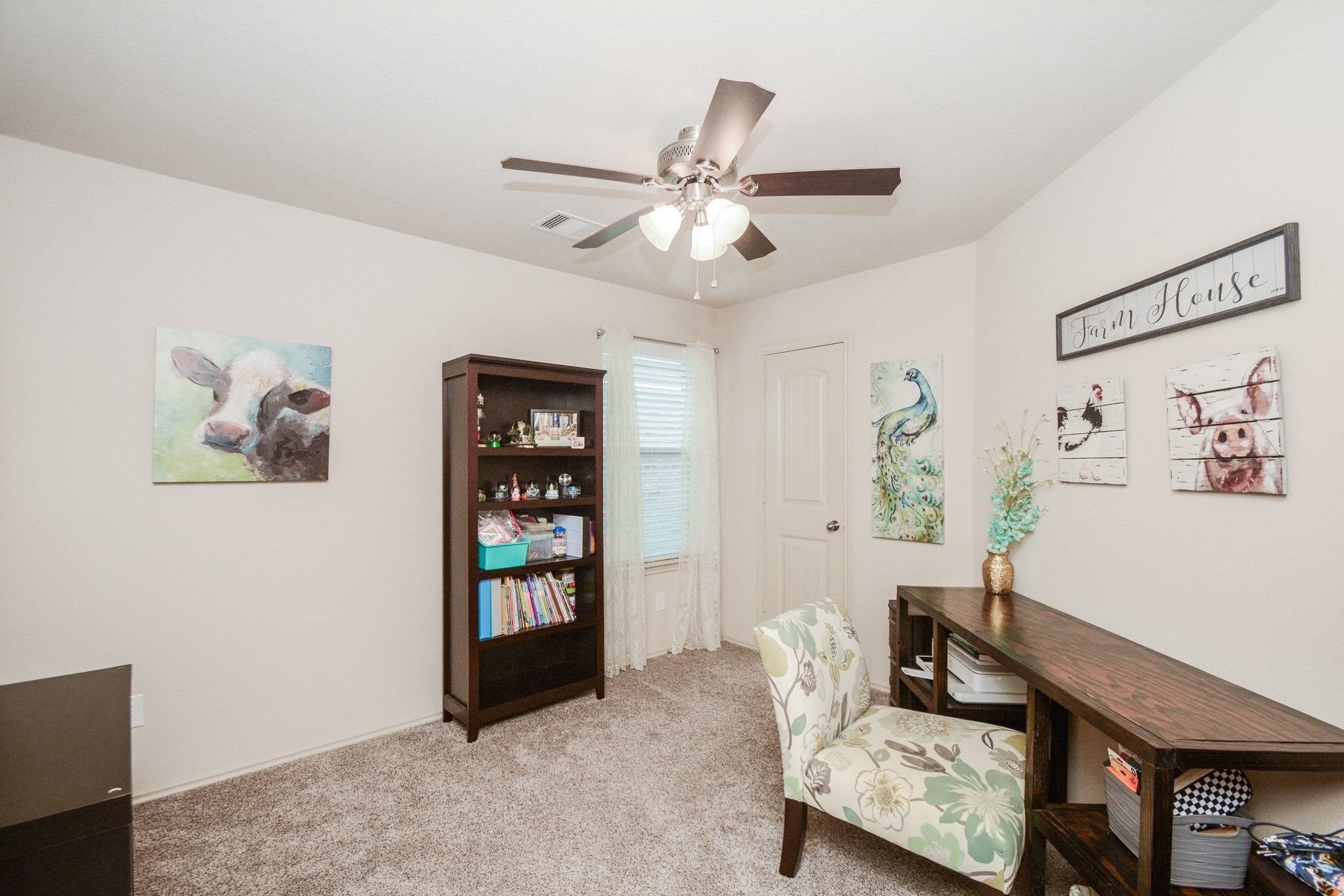 23318 Dukes Run Drive Spring, TX 77373 - Photo 22 of 41 This cozy room features soft carpeting and neutral walls, a ceiling fan, and ample natural light from a window, creating a warm, and inviting space.