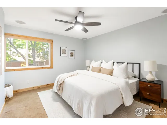 a bedroom with bed and window