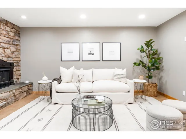 a living room with furniture a couch and a flat screen tv