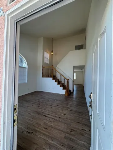a view of a hallway view with wooden floor and staircase