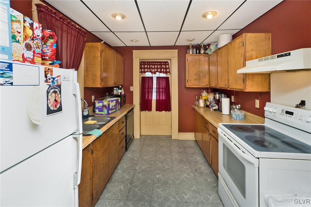 1017 Spring Street Bethlehem, PA 18018 - Photo 7 of 26 a kitchen with stainless steel appliances granite countertop a stove a sink and a refrigerator