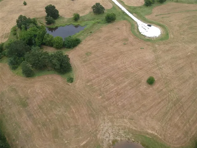 an aerial view of a houses with outdoor space and river