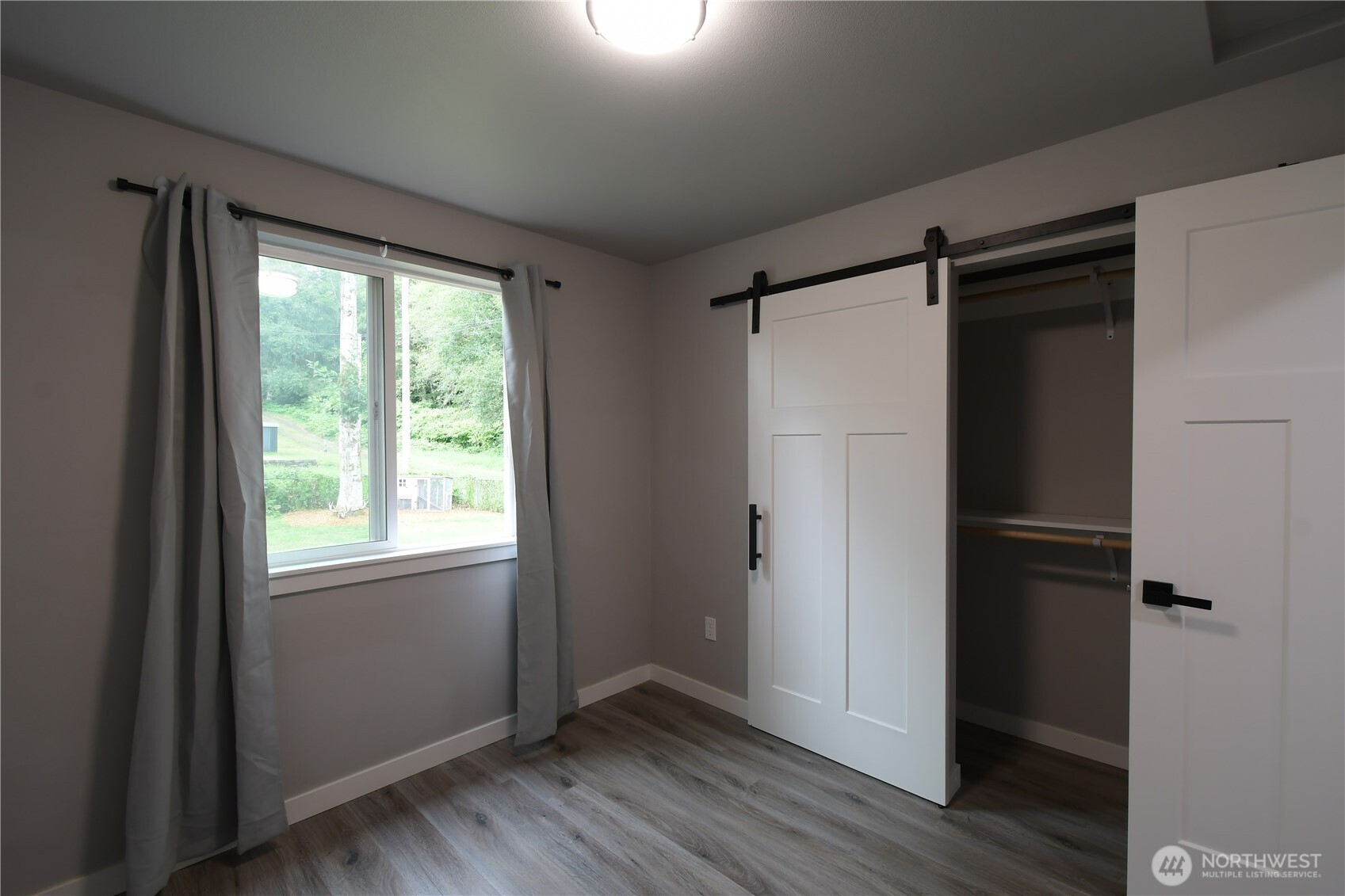 429 Fir Street McCleary, WA 98557 - Photo 17 of 21 an empty room with wooden floor closet and windows