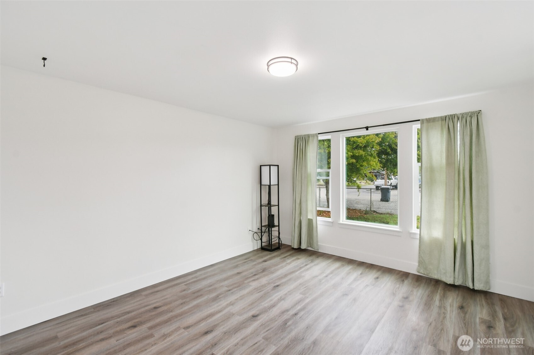 429 Fir Street McCleary, WA 98557 - Photo 7 of 21 a view of empty room with wooden floor and fan