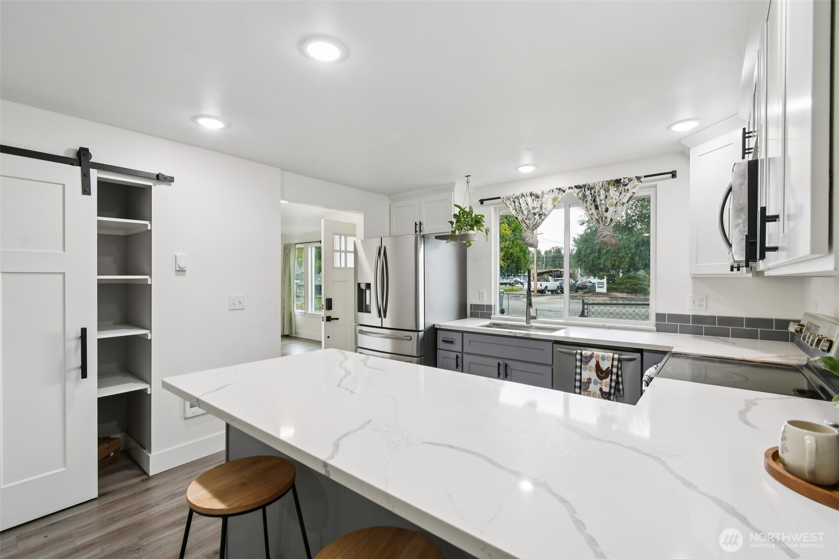 429 Fir Street McCleary, WA 98557 - Photo 8 of 21 a large kitchen with kitchen island a sink stainless steel appliances and cabinets