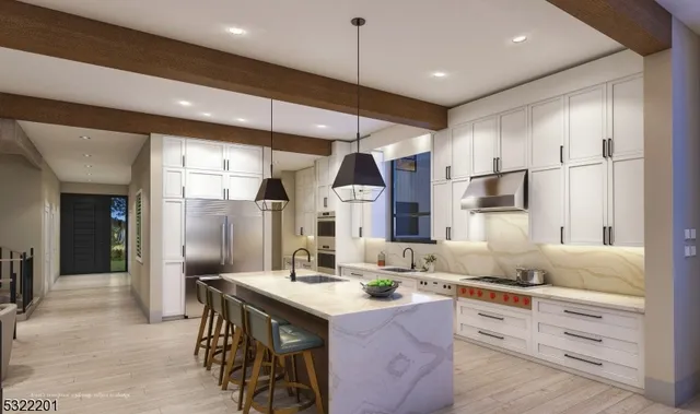 a kitchen with granite countertop kitchen island stainless steel appliances a refrigerator a sink and white cabinets