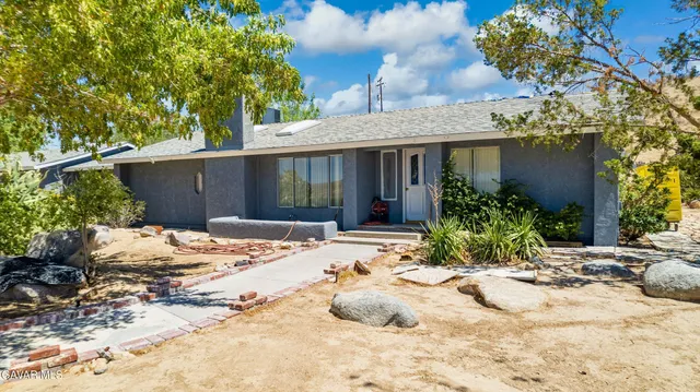 a view of a house with a snow in the yard