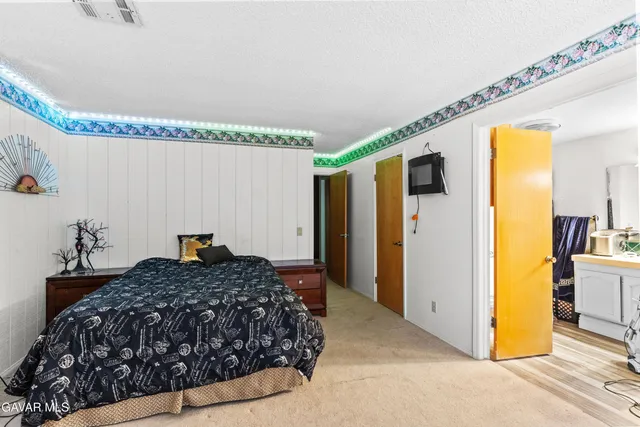 a bedroom with a bed and a dresser