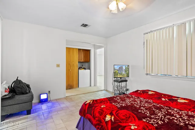 a bedroom with a bed and a window