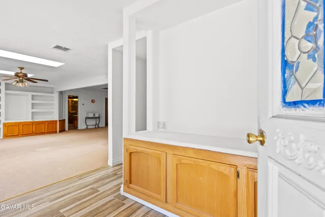 a view of a kitchen with wooden floor and cabinet