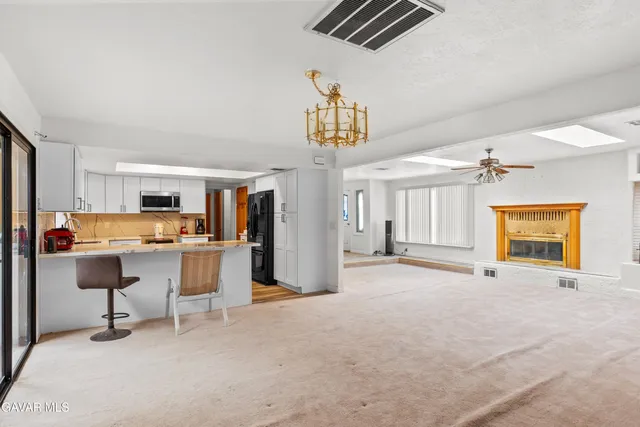 a view of a livingroom with workspace and a window